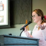 Alison Lapczuk speaking about impact of 100 who care chapters at 100WWC meeting